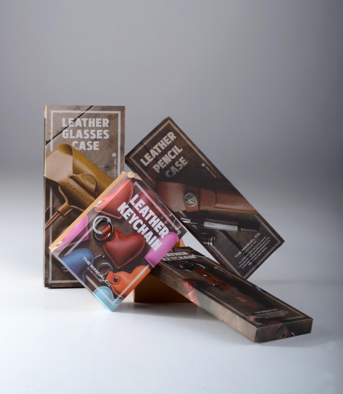 Stacked boxes with leather goods: case, pencil case, keychain