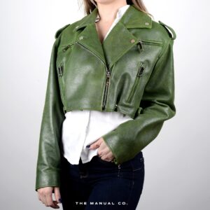 Person in cropped green leather jacket, white shirt, and dark jeans, casual edgy style