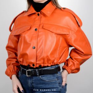  Person in bright orange leather jacket with black buttons, black turtleneck, and blue jeans